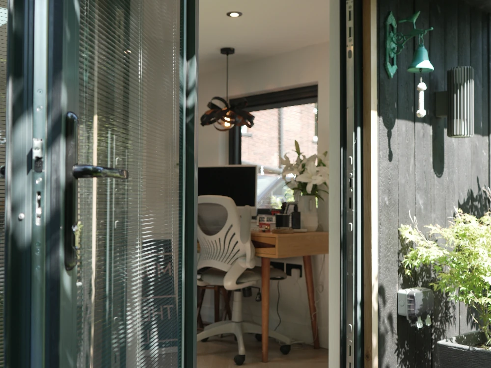 Finished garden room exterior with bifold doors and black cladding