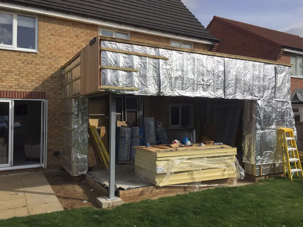 Steel SIP extension wall insulation during construction